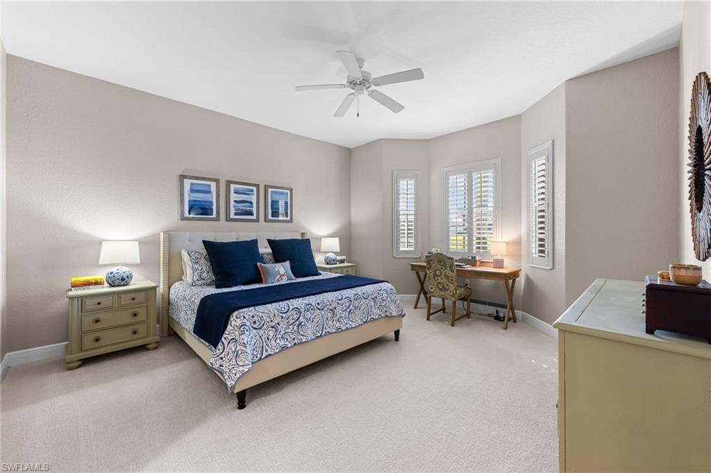 6418 Legacy Circle, Unit 802 Naples, FL 34113 - Photo 13 of 47 a spacious bedroom with a bed and a window