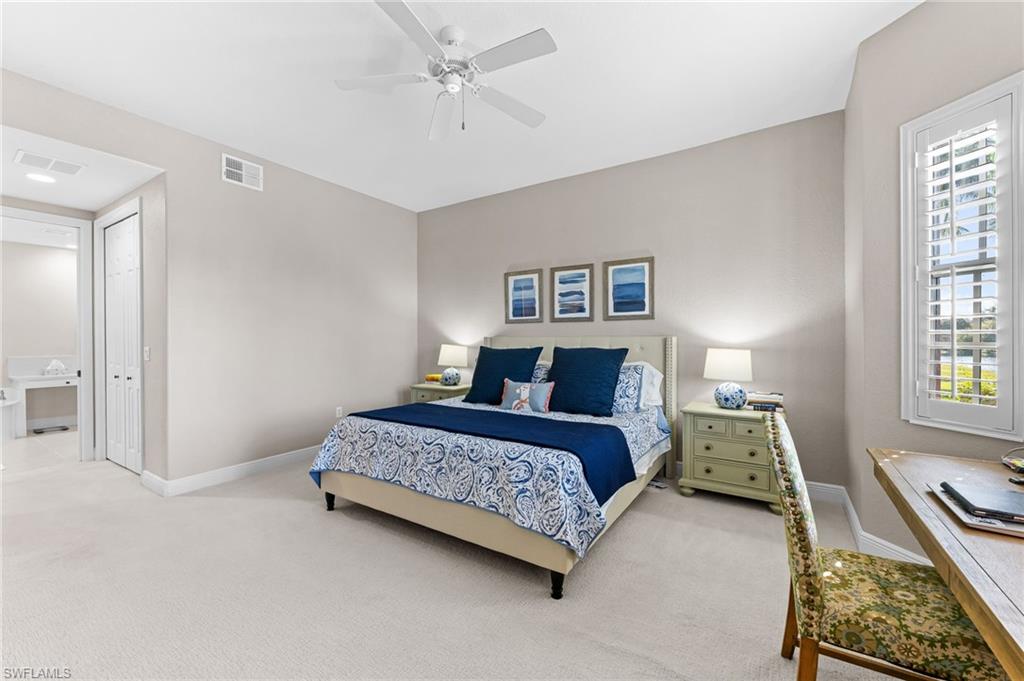 6418 Legacy Circle, Unit 802 Naples, FL 34113 - Photo 14 of 47 a bedroom with a bed couch and a window