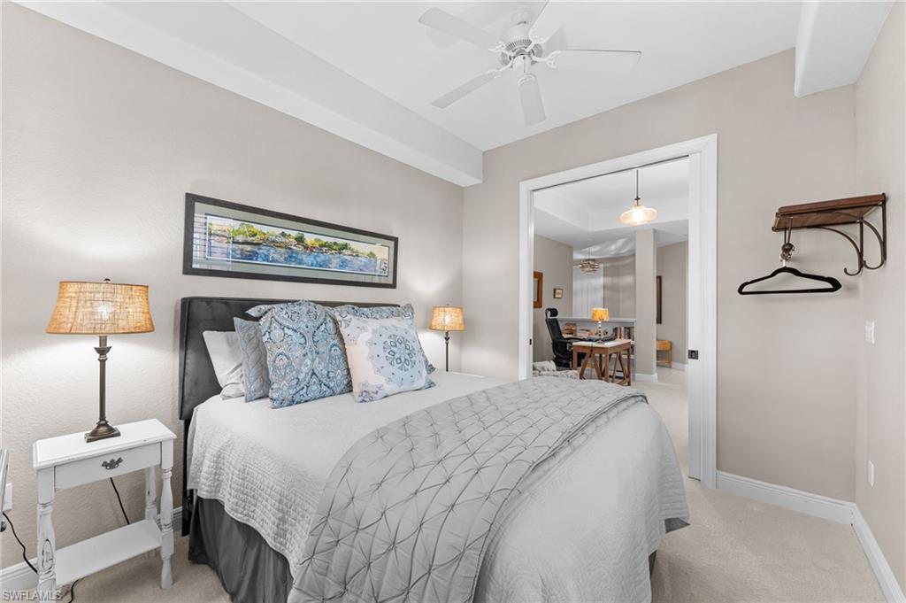 6418 Legacy Circle, Unit 802 Naples, FL 34113 - Photo 18 of 47 a bed room with a bed and a lamp