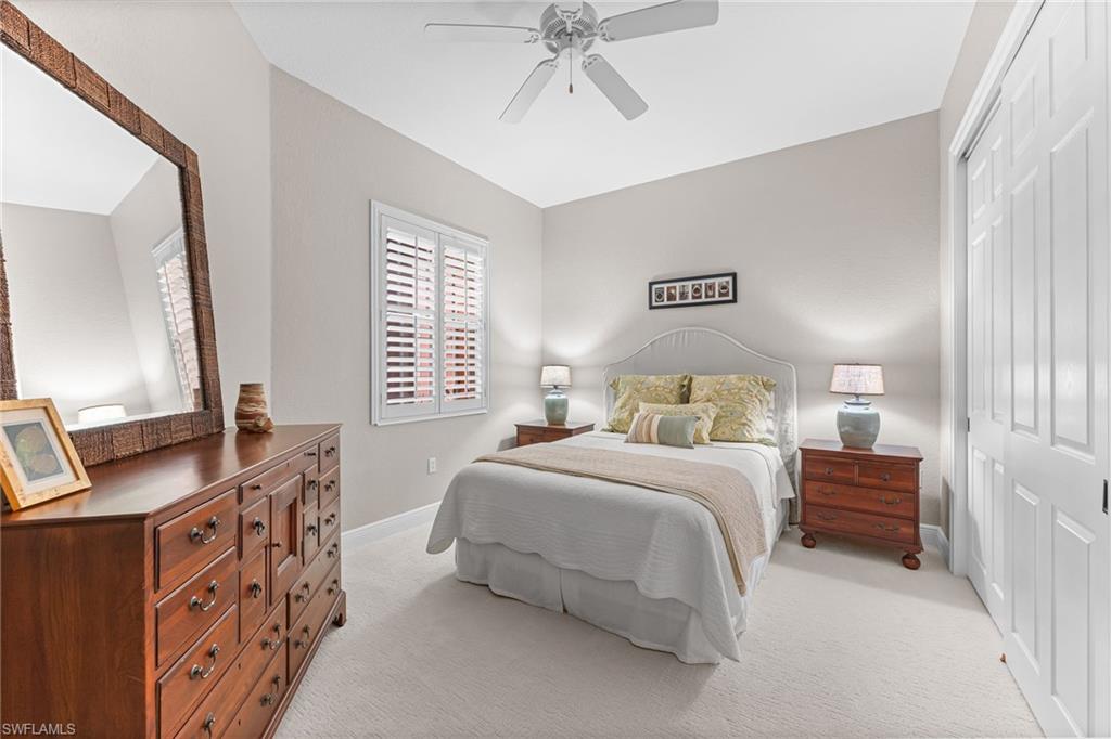 6418 Legacy Circle, Unit 802 Naples, FL 34113 - Photo 20 of 47 a bedroom with a bed and a flat tv screen on dresser