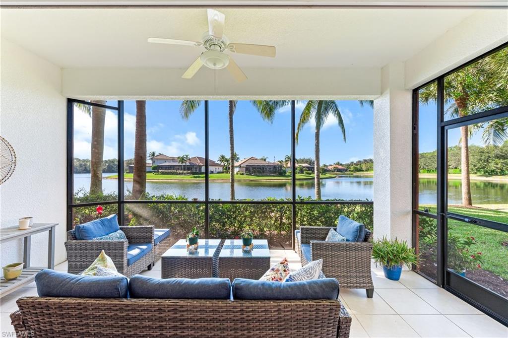 6418 Legacy Circle, Unit 802 Naples, FL 34113 - Photo 23 of 47 a living room with furniture and a floor to ceiling window