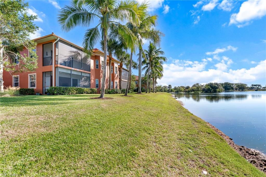 6418 Legacy Circle, Unit 802 Naples, FL 34113 - Photo 24 of 47 a view of a building with a yard