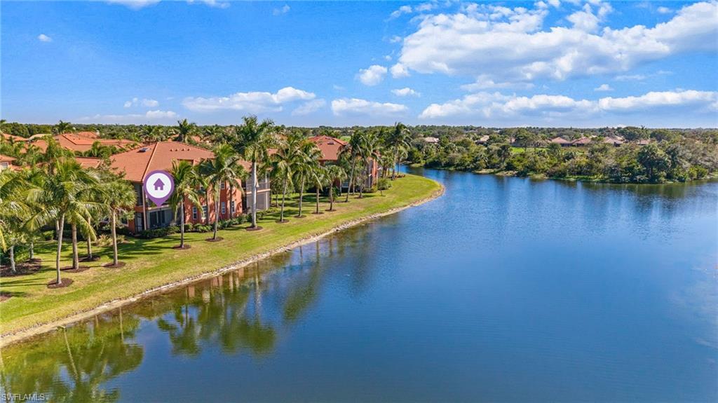 6418 Legacy Circle, Unit 802 Naples, FL 34113 - Photo 32 of 47 a view of a lake with a city