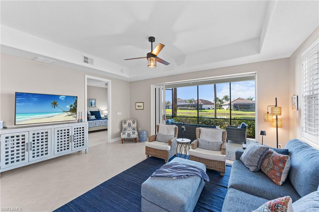 6418 Legacy Circle, Unit 802 Naples, FL 34113 - Photo 4 of 47 a living room with furniture and a floor to ceiling window