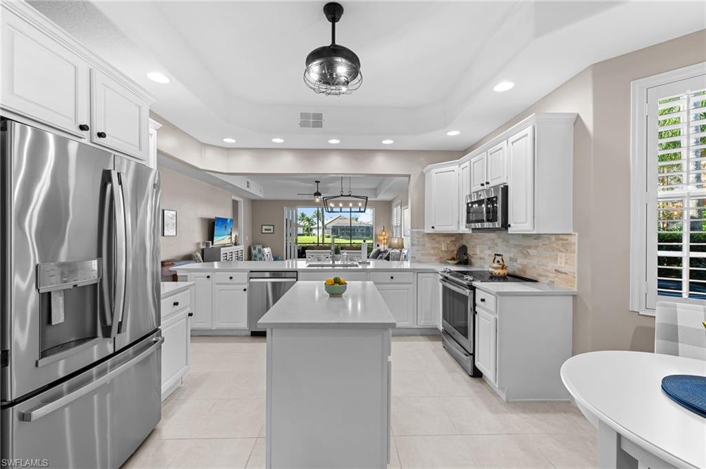 6418 Legacy Circle, Unit 802 Naples, FL 34113 - Photo 6 of 47 a kitchen with appliances cabinets and a counter top space