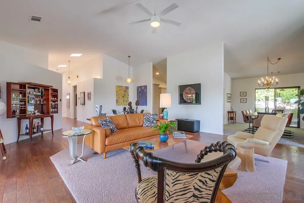 924 Ridge Heights Drive Fallbrook, CA 92028 - Photo 17 of 75 a living room with furniture a wooden floor and a chandelier