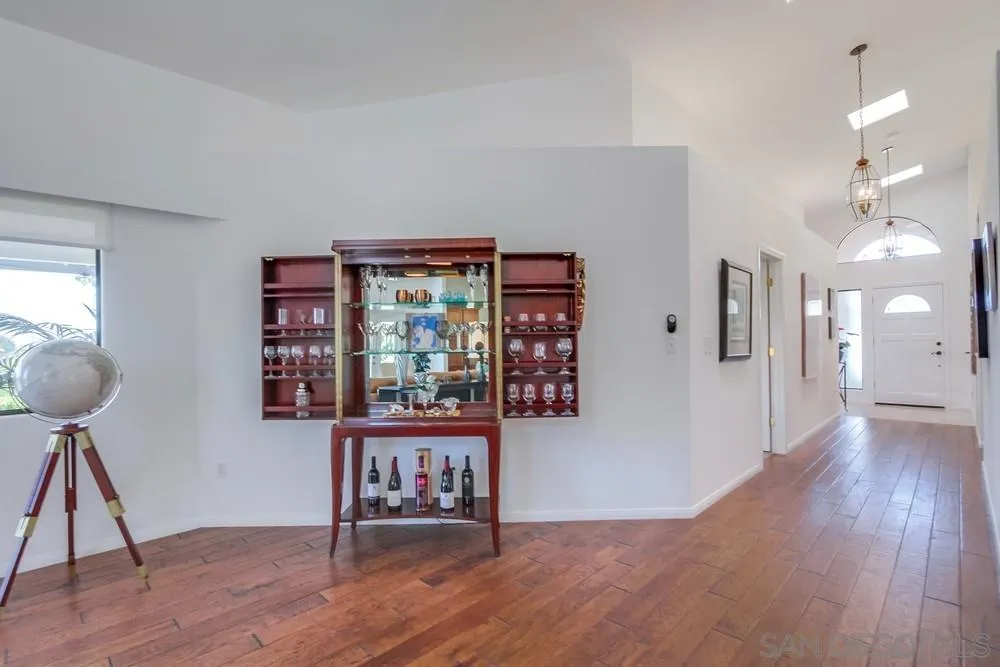 924 Ridge Heights Drive Fallbrook, CA 92028 - Photo 23 of 75 a view of a hallway with wooden floor and a living room