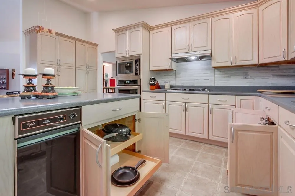 924 Ridge Heights Drive Fallbrook, CA 92028 - Photo 29 of 75 a kitchen with granite countertop a stove sink and cabinets