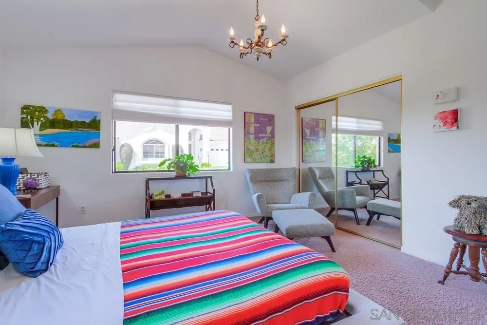 924 Ridge Heights Drive Fallbrook, CA 92028 - Photo 34 of 75 a bedroom with a bed a chandelier and a couch