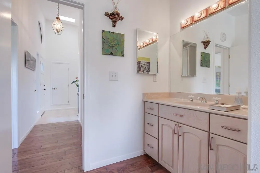924 Ridge Heights Drive Fallbrook, CA 92028 - Photo 38 of 75 a bathroom with a granite countertop sink a mirror and a shower