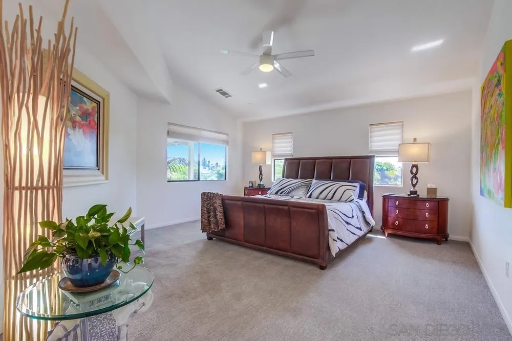 924 Ridge Heights Drive Fallbrook, CA 92028 - Photo 39 of 75 a spacious bedroom with a bed and a chandelier