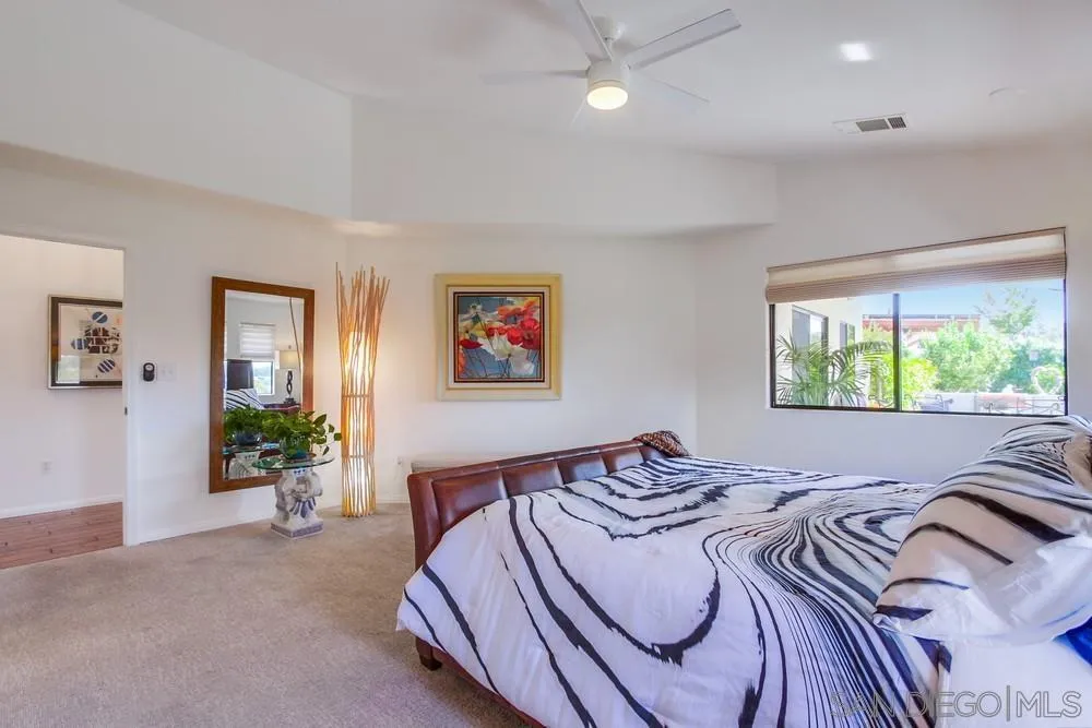 924 Ridge Heights Drive Fallbrook, CA 92028 - Photo 40 of 75 a bedroom with a bed and glass windows