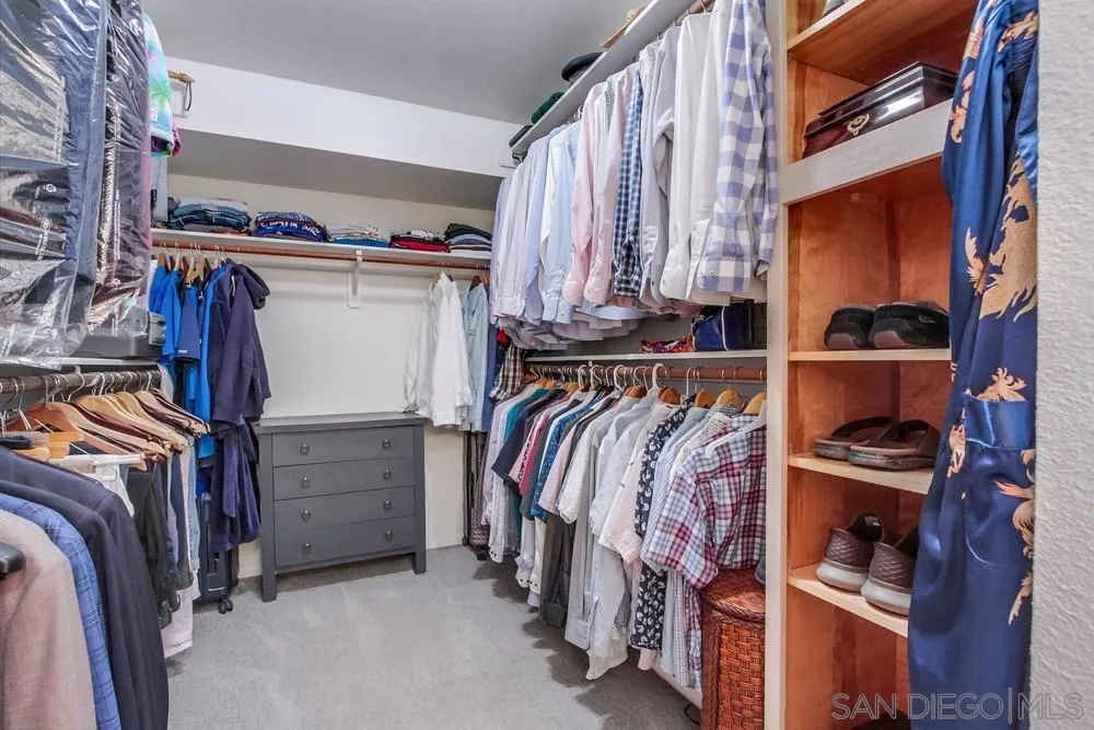 924 Ridge Heights Drive Fallbrook, CA 92028 - Photo 47 of 75 a view of walk in closet with clothes and shoes