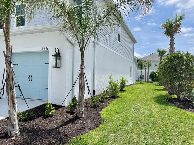 a view of a house with a tree in a yard