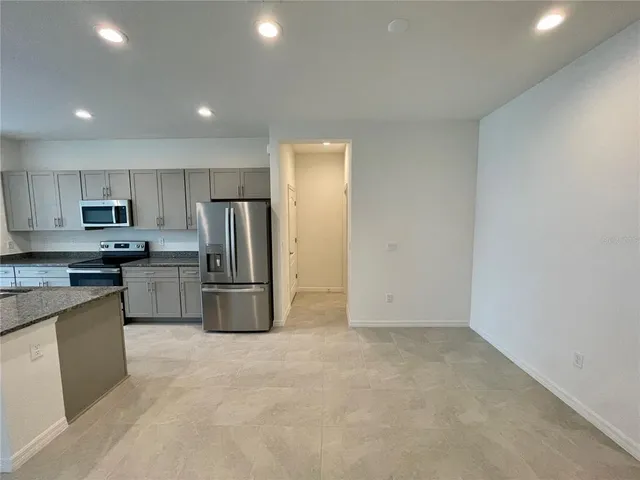 a kitchen with refrigerator and microwave