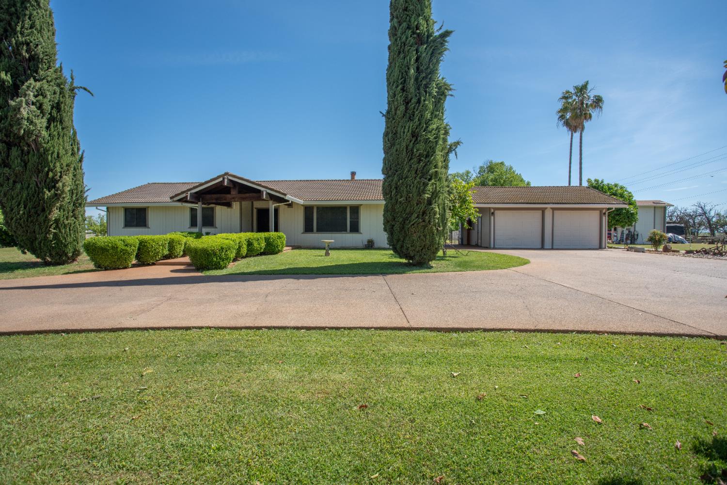 a front view of a house with a garden and yard