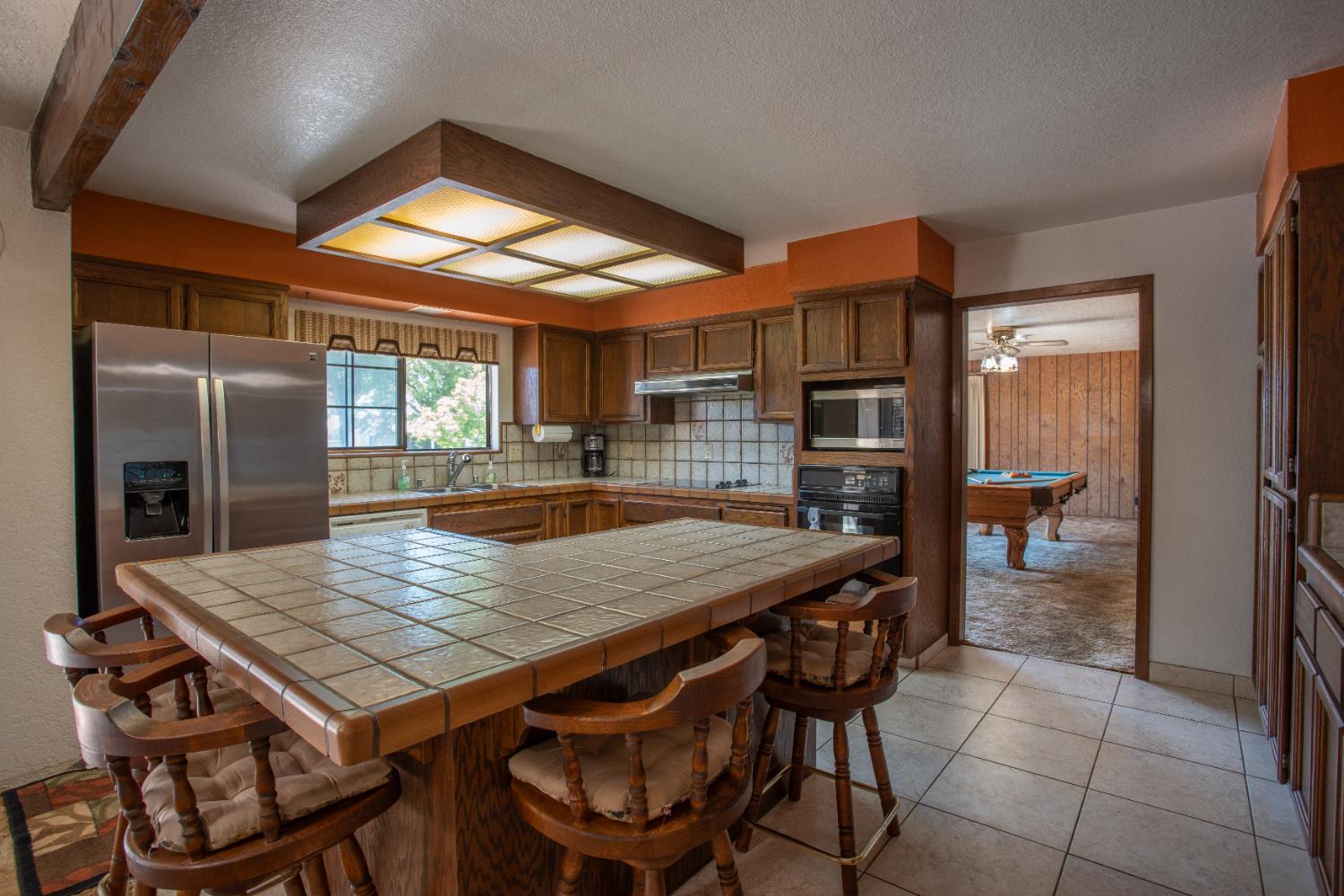 6323 Excelsior Road Sacramento, CA 95830 - Photo 19 of 75 a kitchen with a wooden table and chairs