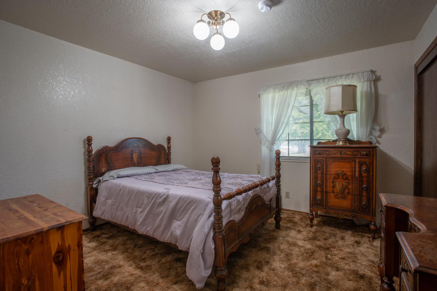 6323 Excelsior Road Sacramento, CA 95830 - Photo 27 of 75 a bedroom with a bed and a table in it