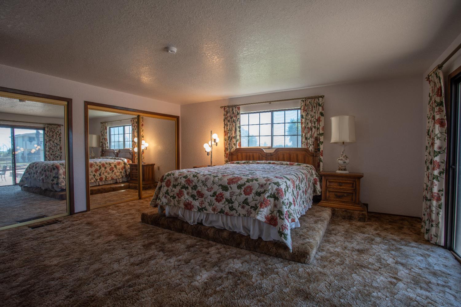 6323 Excelsior Road Sacramento, CA 95830 - Photo 32 of 75 a bedroom with a large bed and two large window