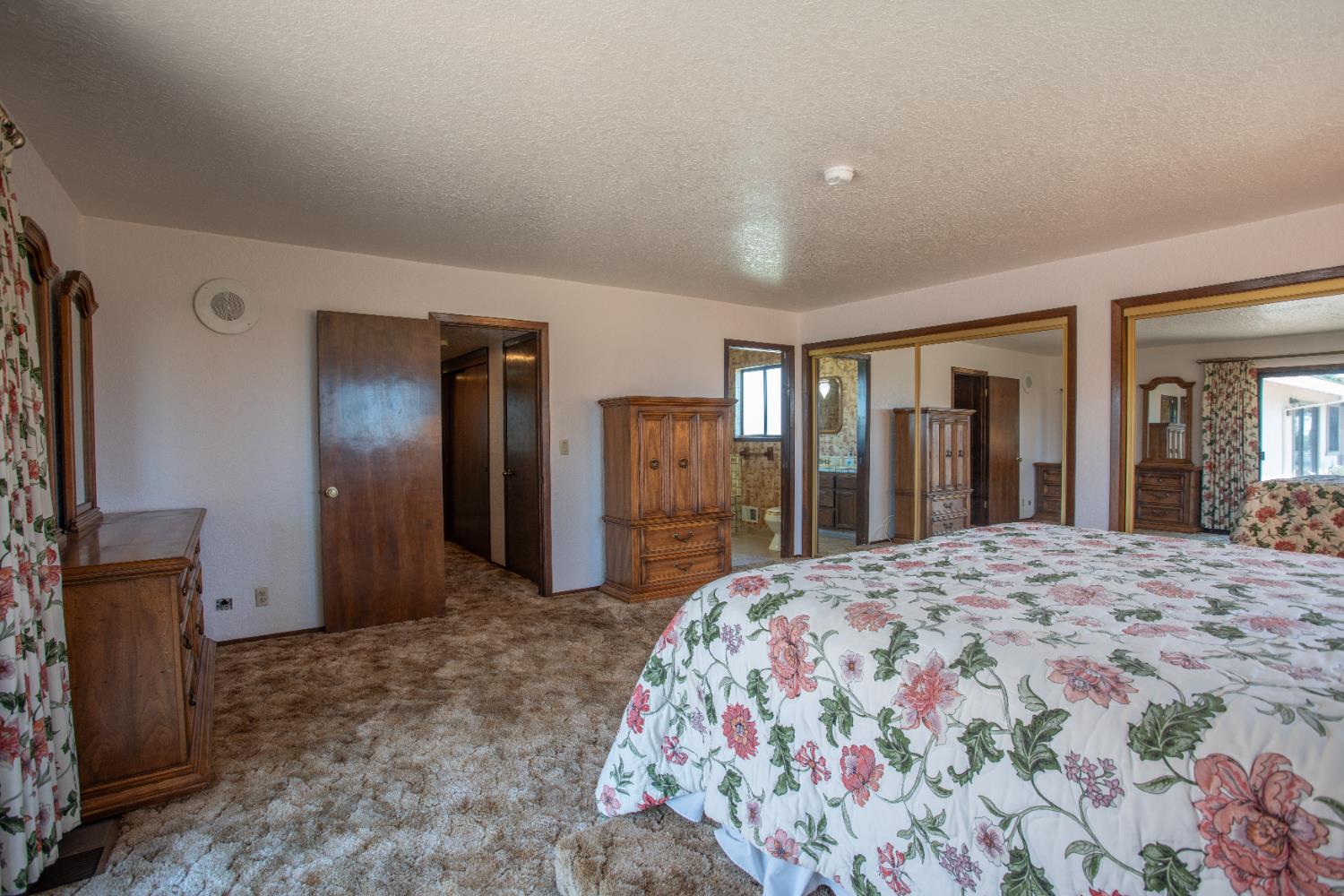 6323 Excelsior Road Sacramento, CA 95830 - Photo 33 of 75 a bedroom with a large bed and a dresser