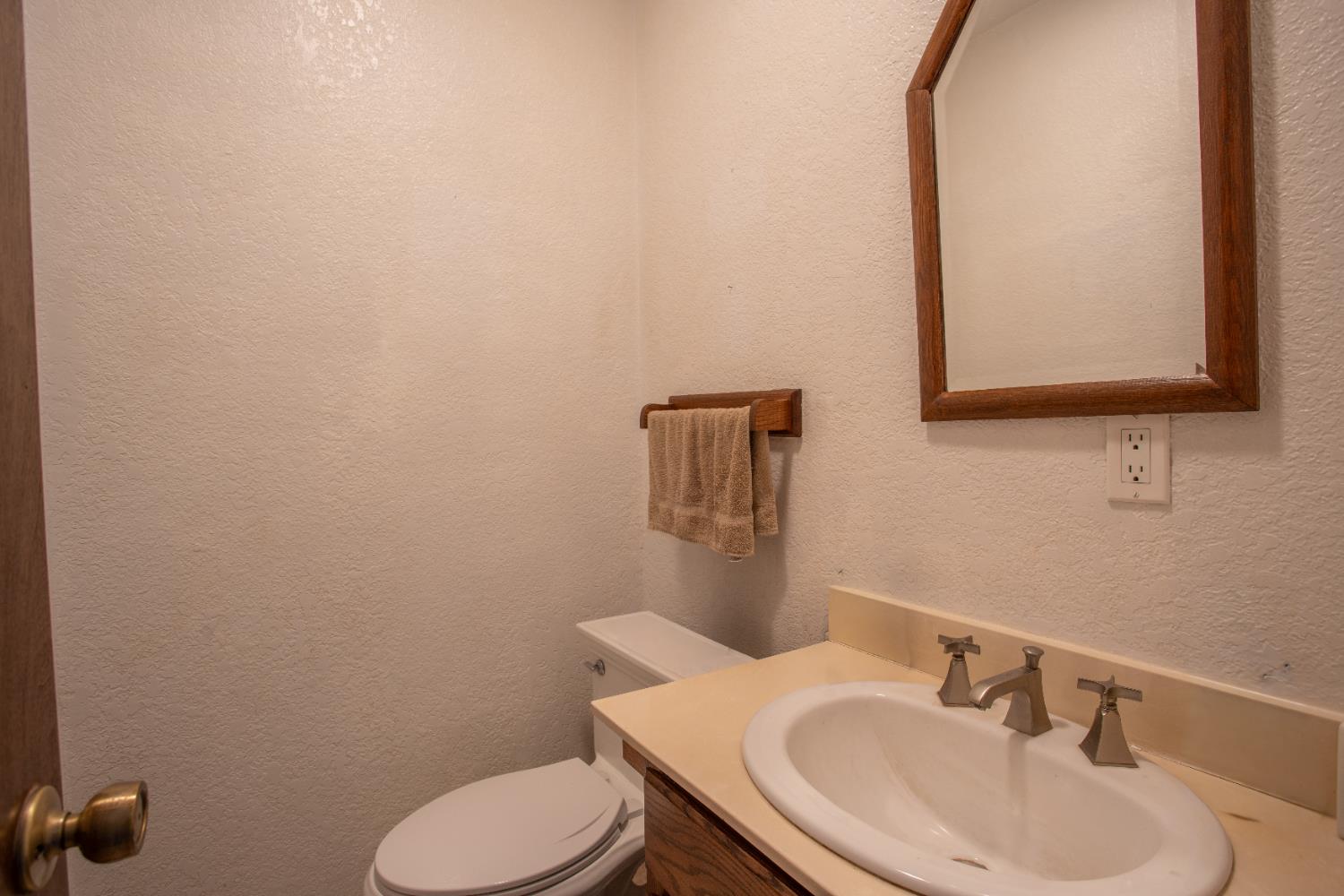 6323 Excelsior Road Sacramento, CA 95830 - Photo 38 of 75 a bathroom with a toilet sink and mirror