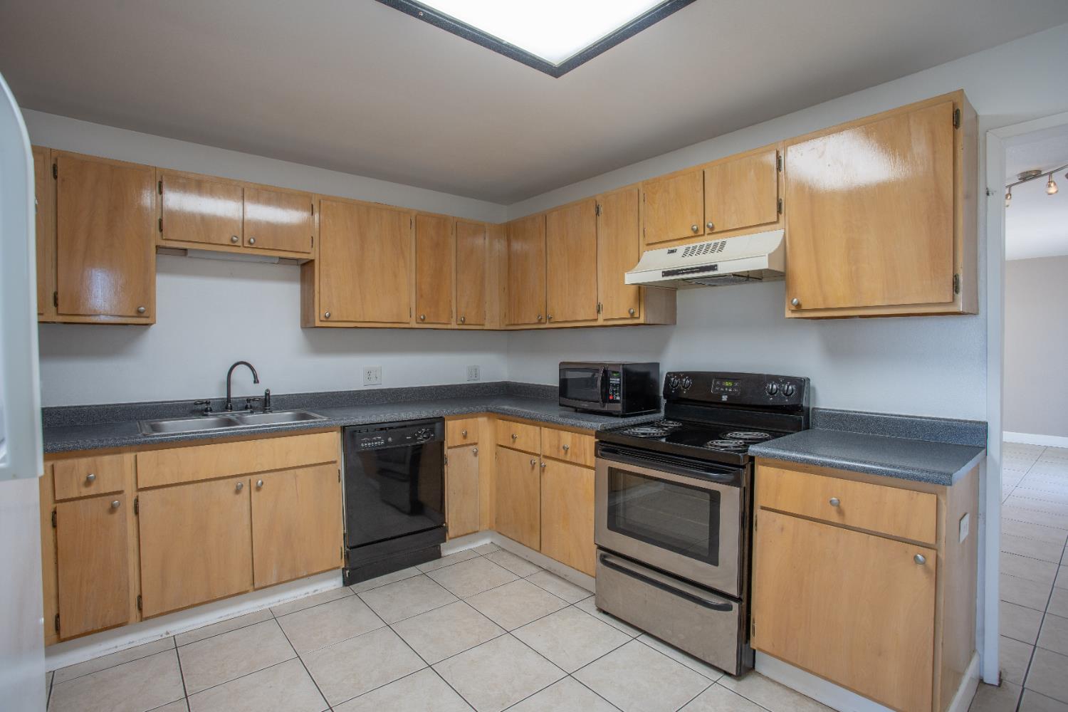 6323 Excelsior Road Sacramento, CA 95830 - Photo 52 of 75 a kitchen with stainless steel appliances granite countertop a stove a sink and a microwave