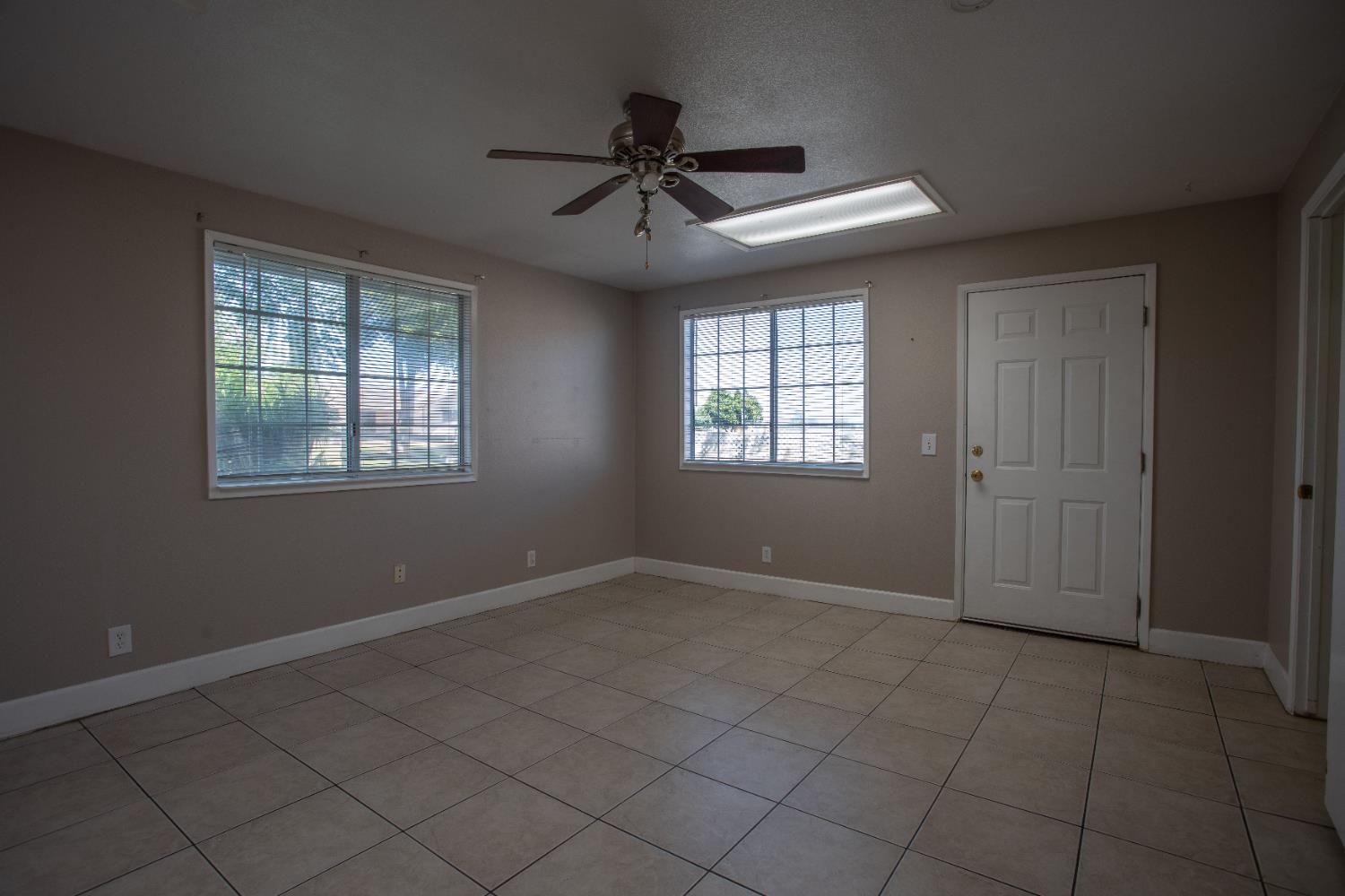 6323 Excelsior Road Sacramento, CA 95830 - Photo 54 of 75 an empty room with windows and fan