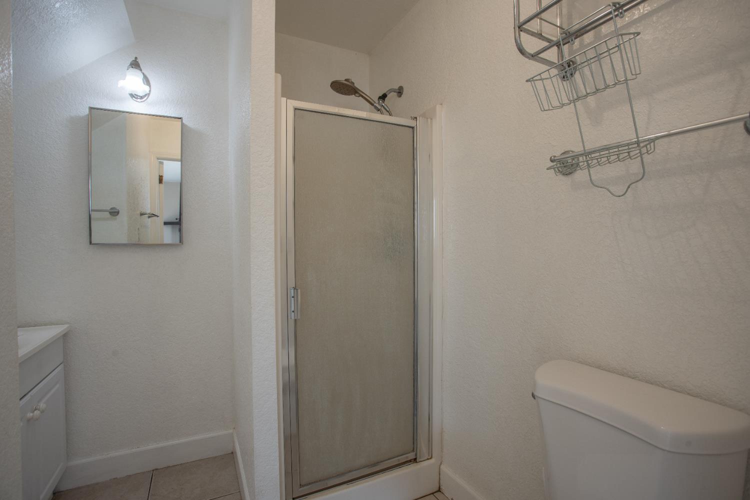 6323 Excelsior Road Sacramento, CA 95830 - Photo 62 of 75 a bathroom with a toilet and shower