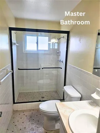 a bathroom with a toilet and a shower