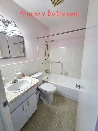a bathroom with a sink a toilet and mirror