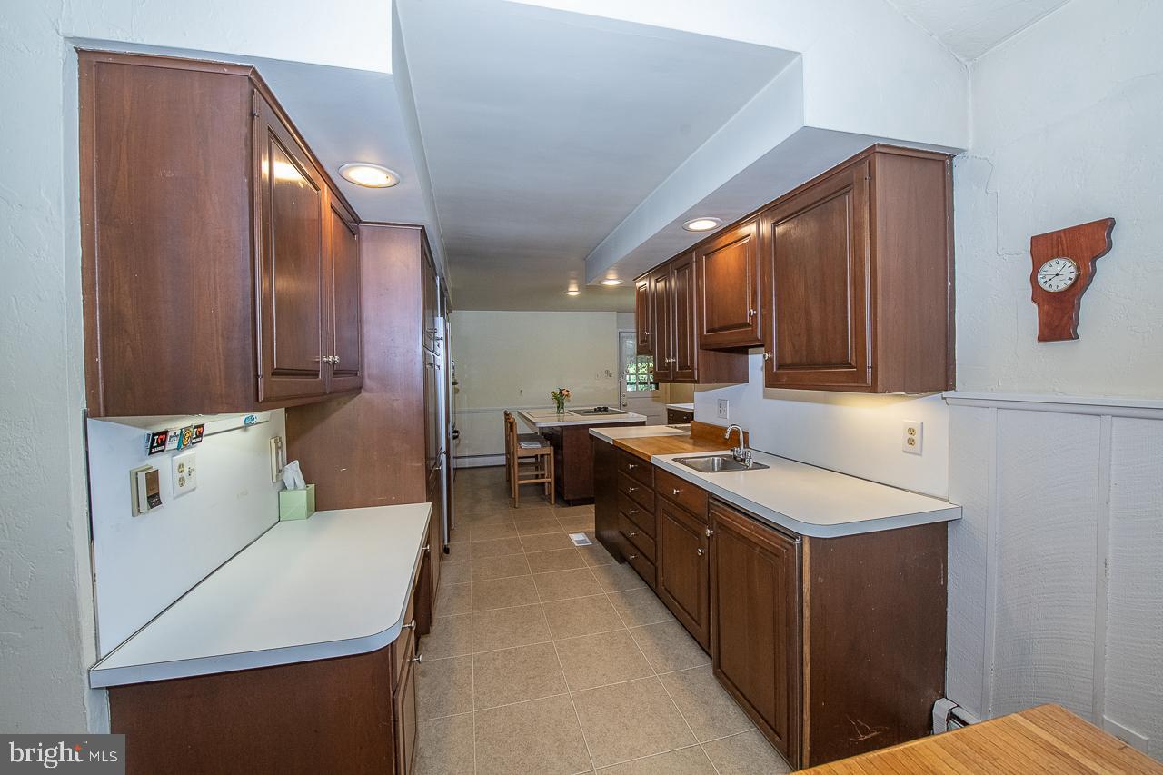 247 Church Road Devon, PA 19333 - Photo 11 of 35 a kitchen with a sink a stove cabinets and wooden floor