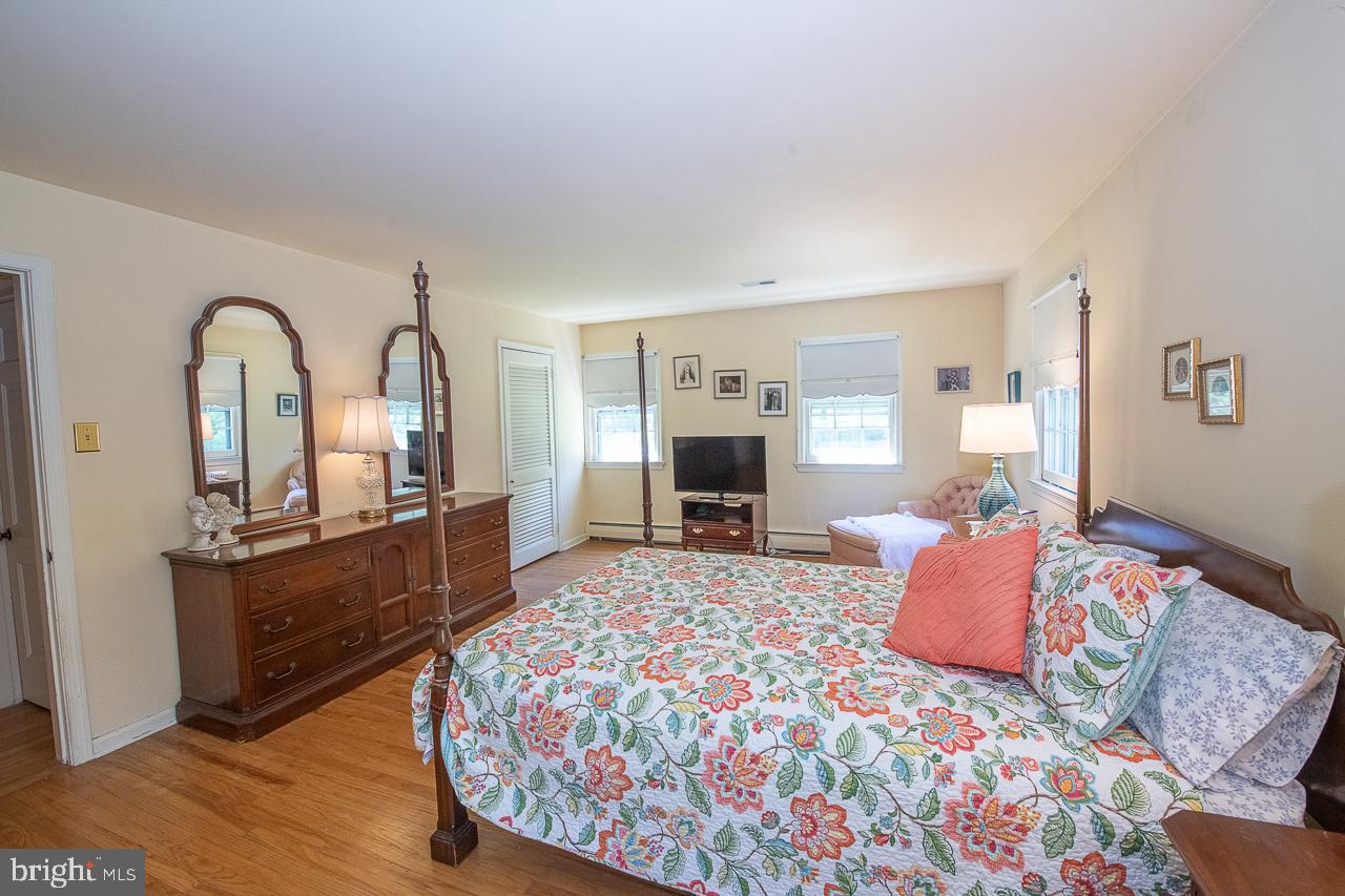 247 Church Road Devon, PA 19333 - Photo 21 of 35 a bedroom with a bed and dresser with mirror