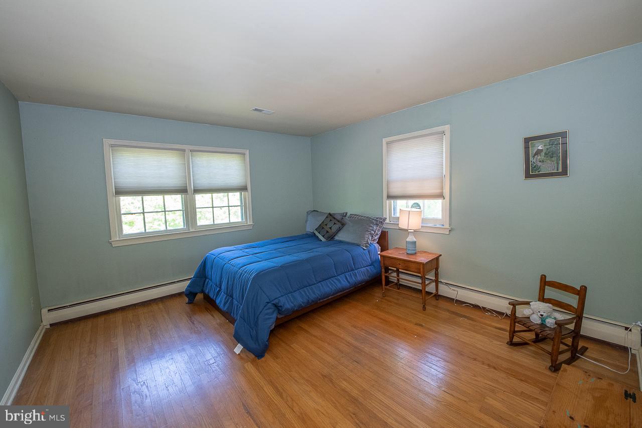 247 Church Road Devon, PA 19333 - Photo 25 of 35 a bedroom with a bed and wooden floor