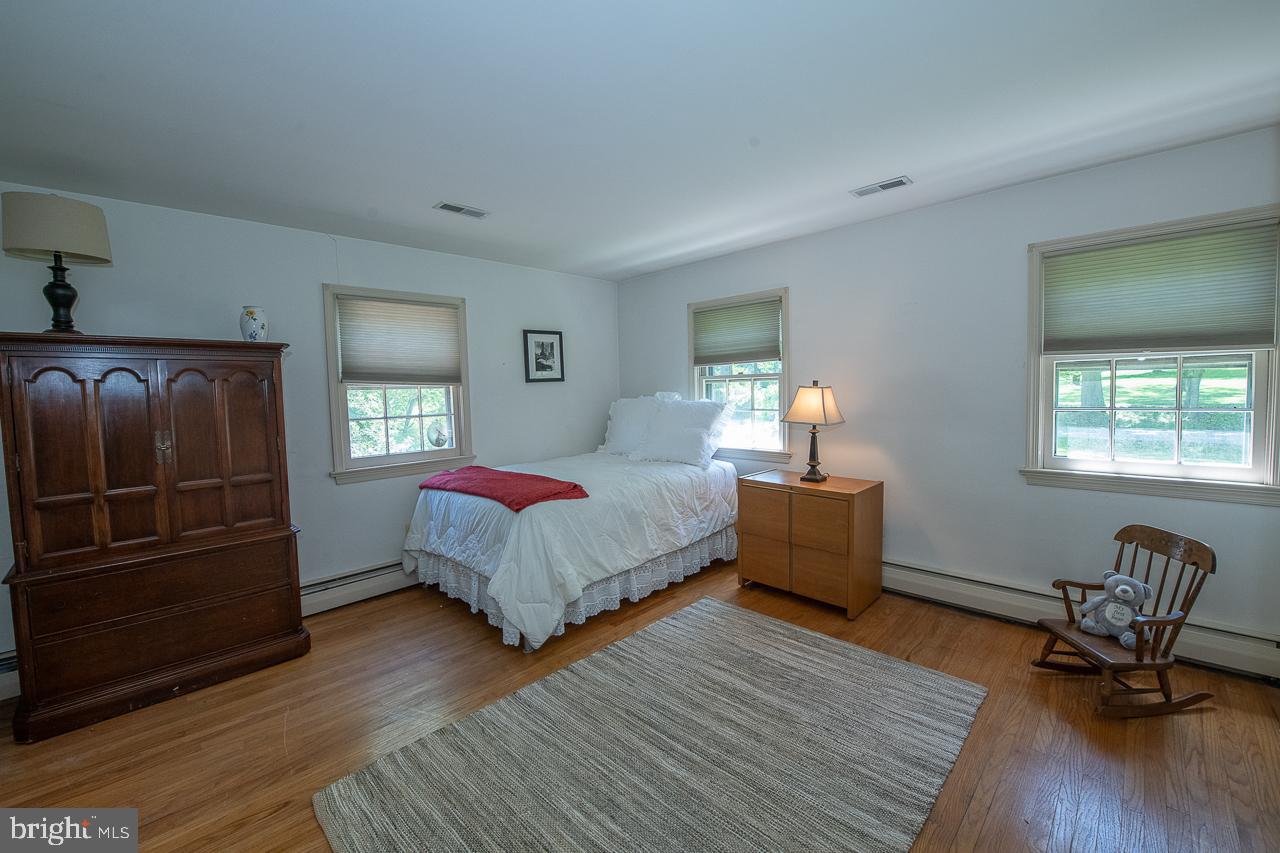 247 Church Road Devon, PA 19333 - Photo 26 of 35 a bedroom with a bed and wooden floor