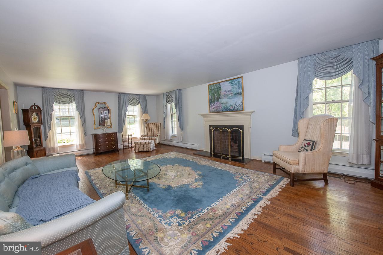 247 Church Road Devon, PA 19333 - Photo 6 of 35 a living room with furniture large window and a fireplace