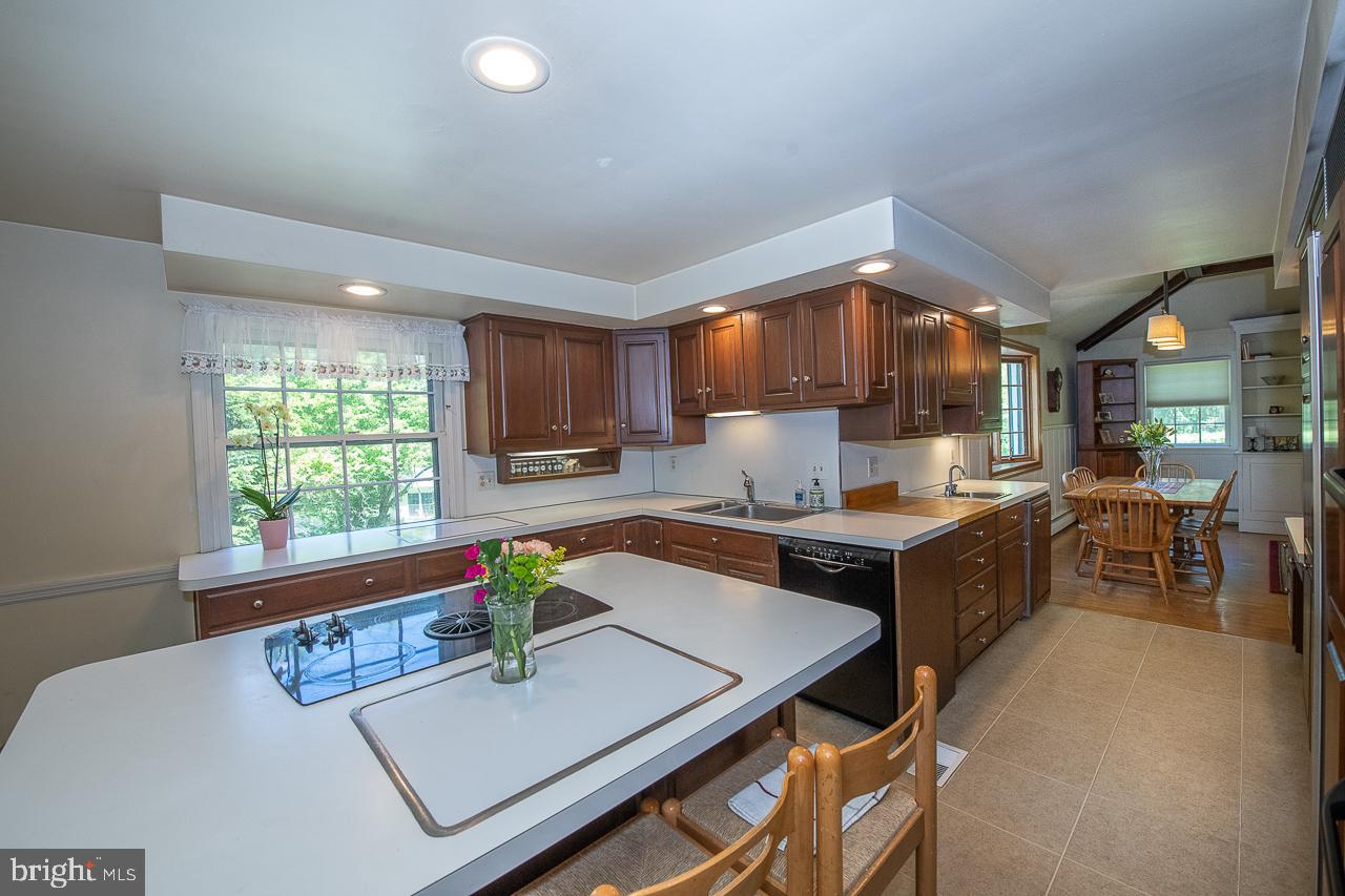 247 Church Road Devon, PA 19333 - Photo 10 of 35 a kitchen with kitchen island granite countertop a stove a sink a counter top space and living room