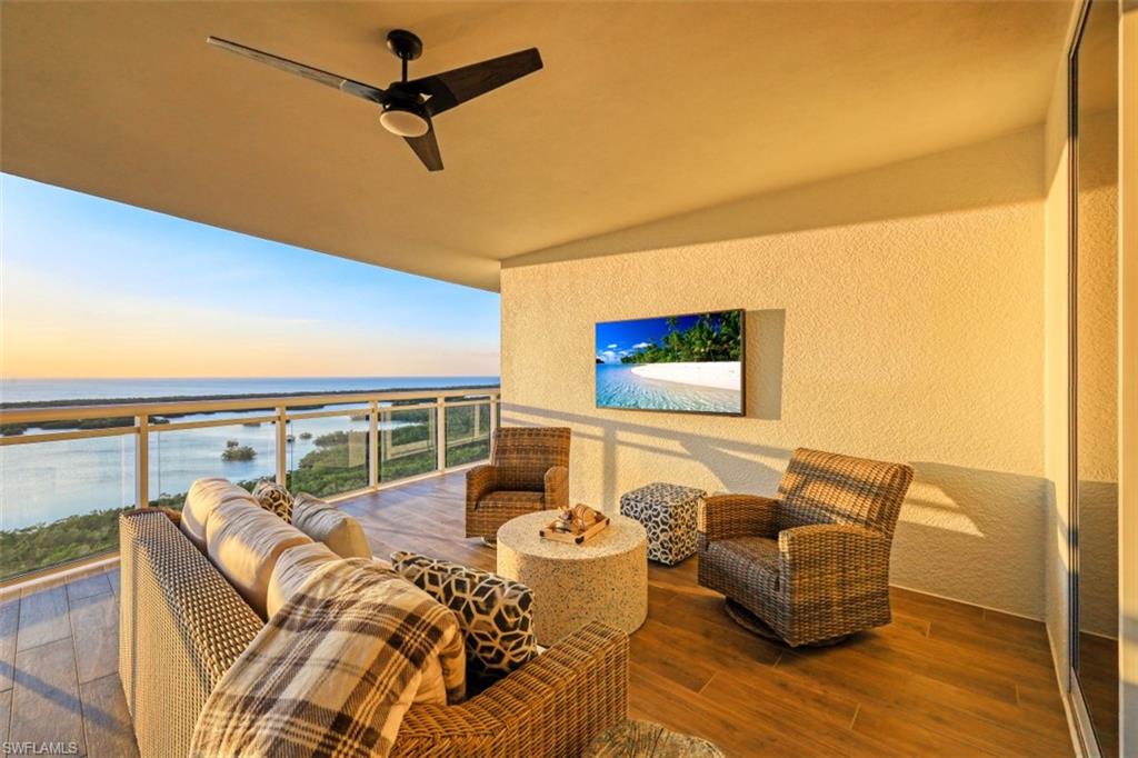 13935 Old Coast Road, Unit 1703 Naples, FL 34110 - Photo 28 of 44 a living room with furniture and a floor to ceiling window