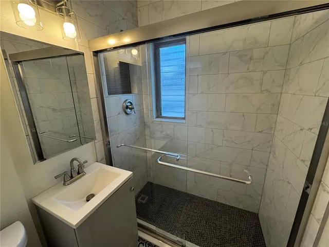 a white toilet sitting next to a sink