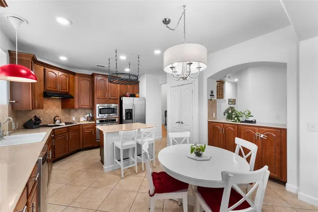 a kitchen with a sink stainless steel appliances a sink and cabinets
