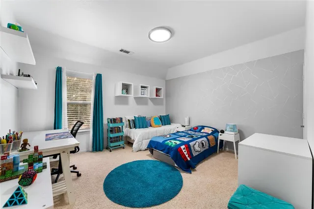 a bedroom with a bed and a couch