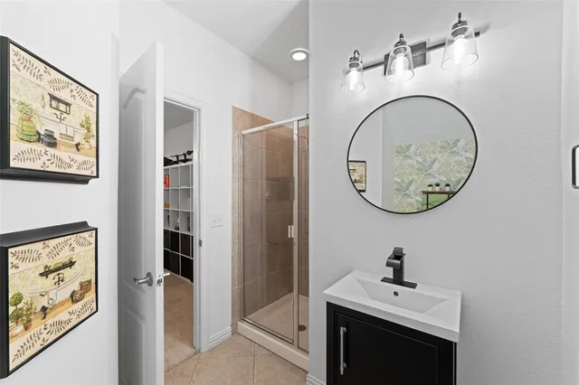 a bathroom with a sink double vanity tub and a mirror