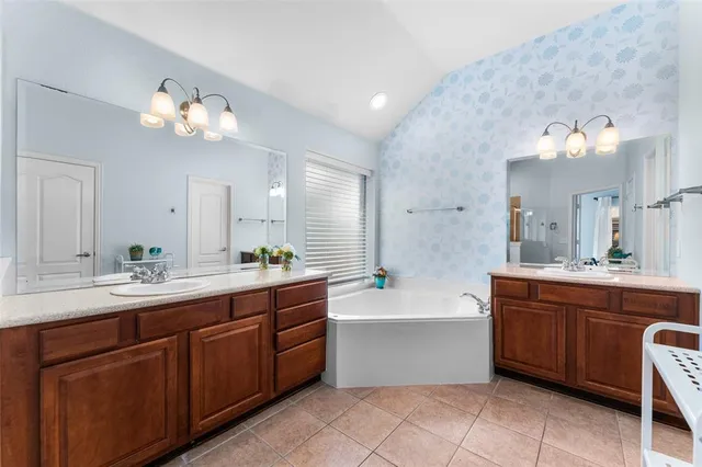a large bathroom with a large tub and sink