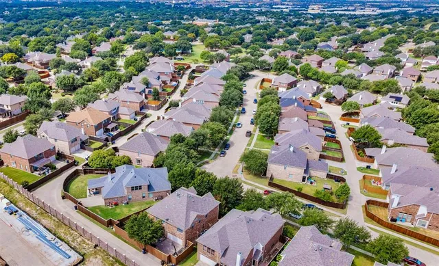 an aerial view of a house with a yard basket ball court and outdoor seating