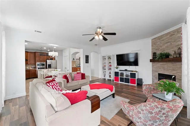 a living room with fireplace furniture and a flat screen tv