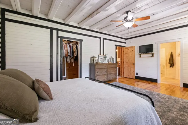 a bathroom with a granite countertop sink a mirror and a shower