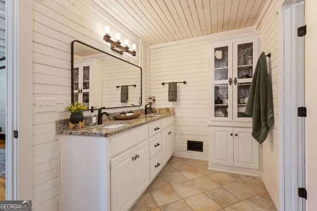 a kitchen with stainless steel appliances kitchen island granite countertop a sink and cabinets