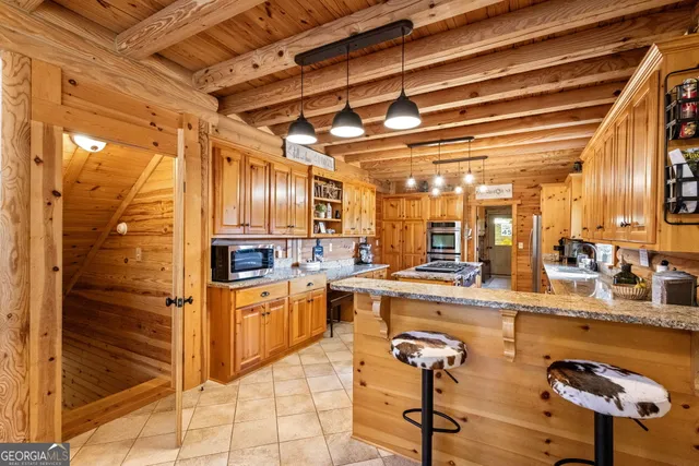 a view of a room with wooden floor and flat screen tv