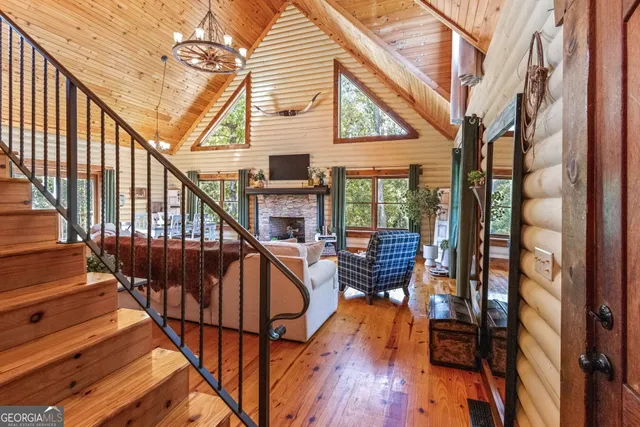 a living room with furniture large window and a fireplace