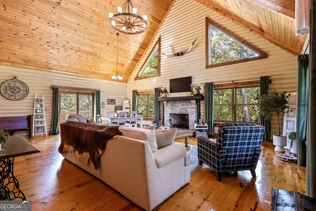 a living room with furniture a rug and a table