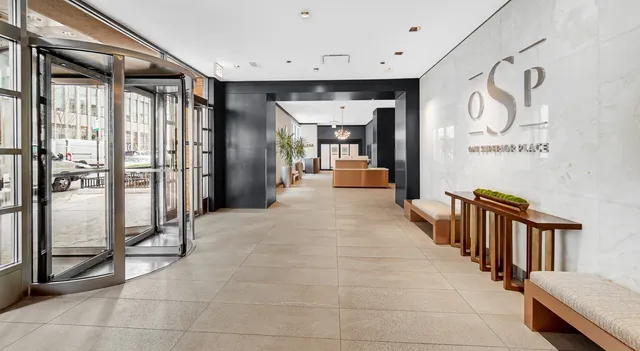 a hallway with a dining table and chairs